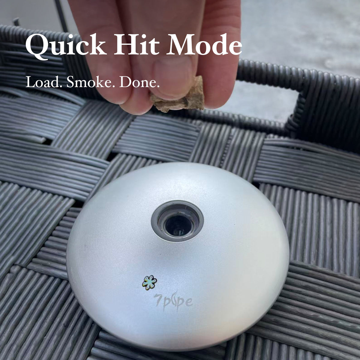 SUKA UFO Pipe in Quick Hit Mode with a Hand Demonstrating the Portable Pipe on an Outdoor Table